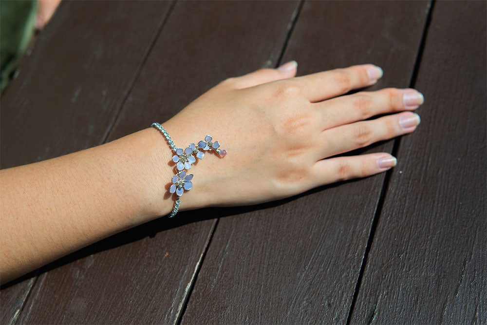 An elegant bracelet adjustable with slider.  Wrap around your wrist lavender flowers cascading from crystal chain. 
