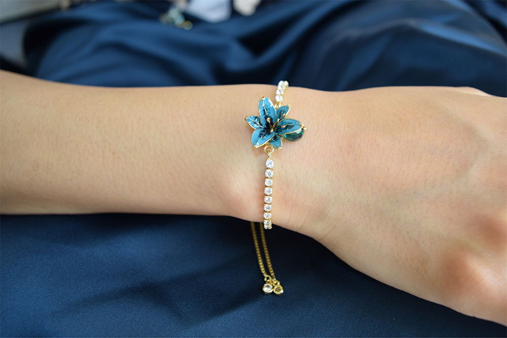 An elegant bracelet with adjustable crystal chain and slider, tiny teal colour Lily flower with a glass bead in the centre, handmade bracelet.