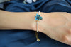 An elegant bracelet with adjustable crystal chain and slider, tiny teal colour Lily flower with a glass bead in the centre, handmade bracelet.