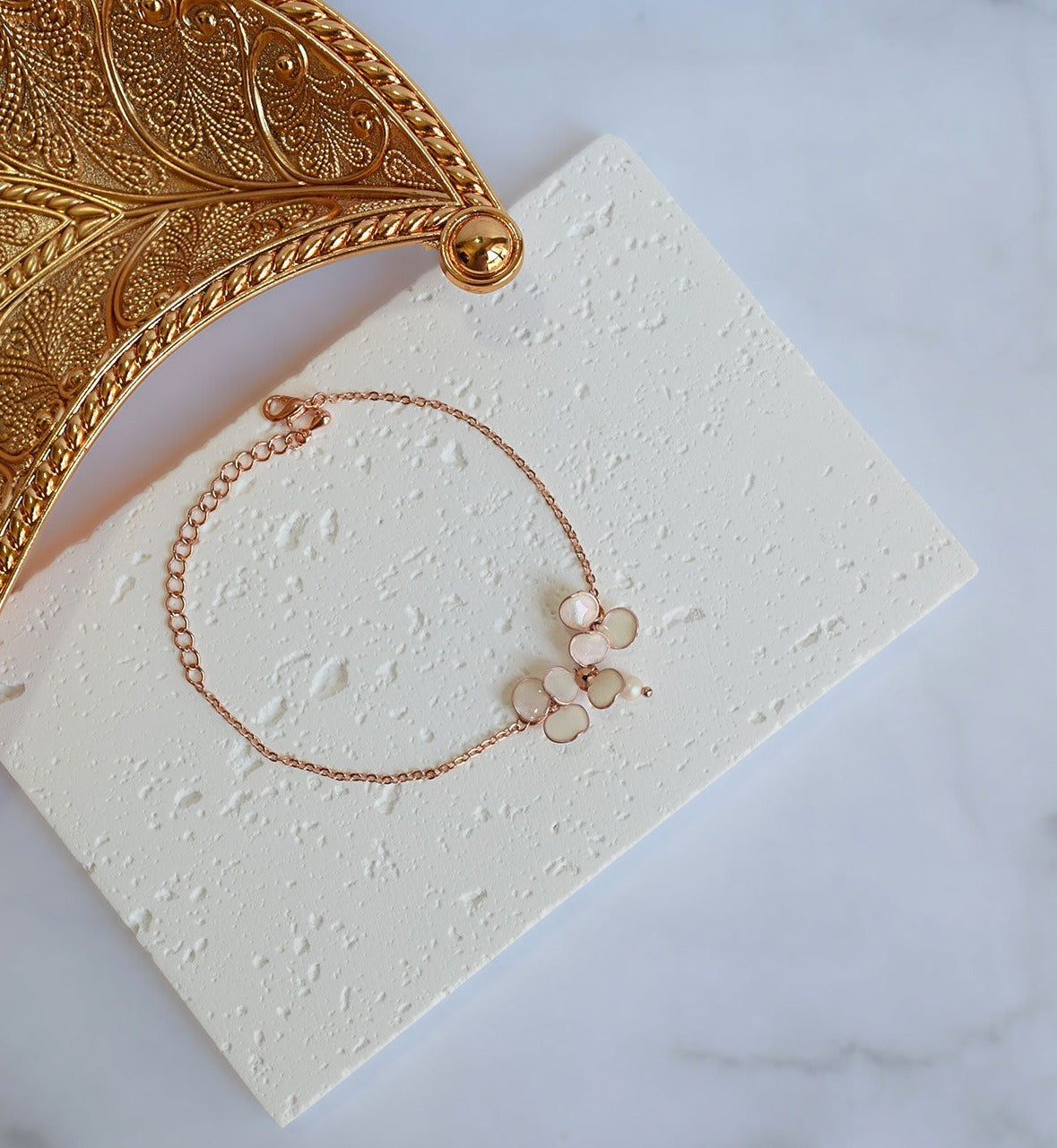 A handmade Rose gold adjustable bracelet with blush pink flowers.