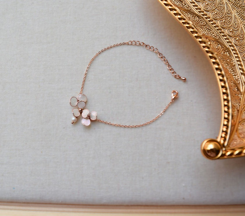 A handmade Rose gold adjustable bracelet with blush pink flowers.