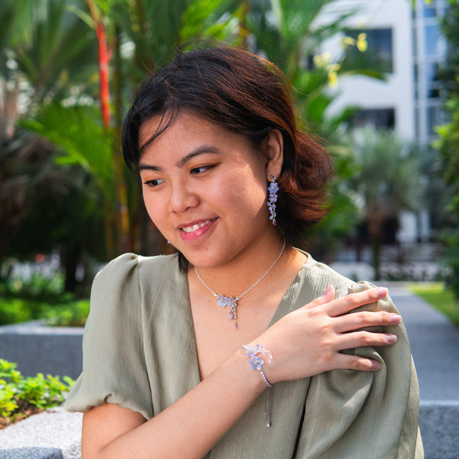 A delicate and elegant choker is handmade with tiny cascading Lavender/purple floral pendant with dangling Zircon teardrop. Matching long earrings dangling with tiny flowers and a zircon. Lavender flower bracelet is adjustable with slider and crystal chain.