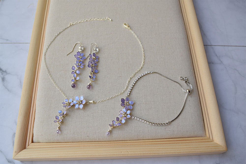 A delicate and elegant choker is handmade with tiny cascading Lavender/purple floral pendant with Zircon teardrop. Matching long earrings dangling with tiny flowers and a zircon. Lavender flower bridal bracelet is adjustable with slider and crystal chain. Excellent jewellery for Wedding, Prom or casual wear. 