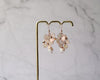Rose gold dangle earrings with hand formed blush flowers, Swarovski pearl and rose gold bicone beads.