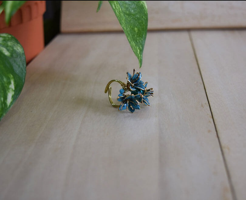 A bright and bold cocktail finger ring adjustable with 3 teal Lily flowers and turquoise beads