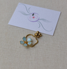 Forget-Me-Not finger ring with slider chain