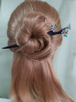 A black finish wooden hair stick with tiny Forget-Me-Not sky blue flowers hair stick for buns.