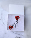 A hand formed Black wire Poppy flowers Hair pins and Hair forks.