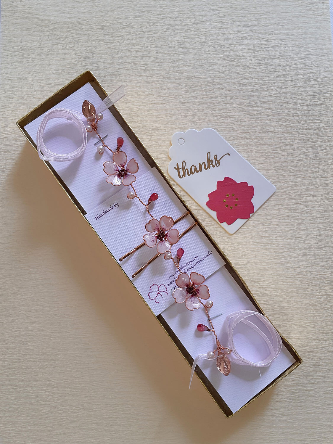 A Delicate 6 inches bridal hair vine in rose gold finish with handmade tiny Sakura/Cherry Blossom flowers in arranged in a row in combination with pink pearls and glass beads. A unique bridal pink hair wrap or hair garland in rose gold finish.