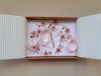 A Delicate 18 inches bridal hair vine in rose gold finish with handmade tiny Sakura/Cherry Blossom flowers in arranged in a row in combination with pink pearls and glass beads. A unique bridal pink hair wrap or hair garland in rose gold finish.