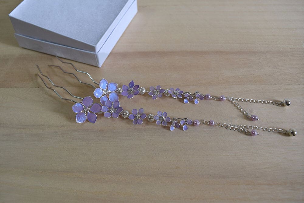 A handmade dangling bridal hair fork, short hair vine with violet/lavender handmade tiny flowers cascading on a chain, pearls and tiny bells.