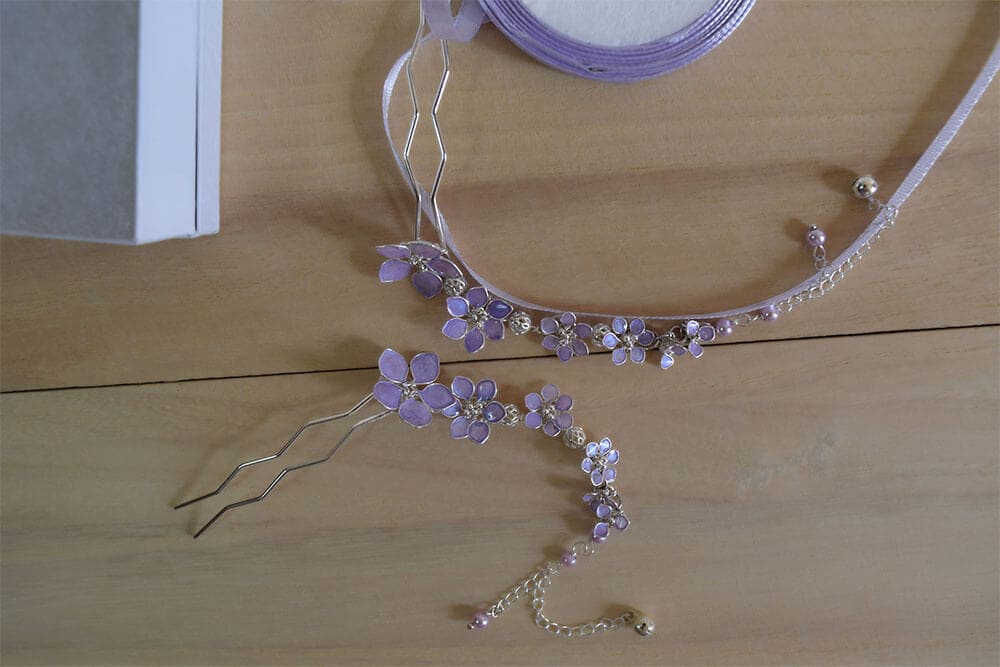 A handmade dangling bridal hair fork, short hair vine with violet/lavender handmade tiny flowers cascading on a chain, pearls and tiny bells.