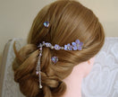 A handmade dangling bridal hair fork, short hair vine with violet/lavender handmade tiny flowers cascading on a chain, pearls and tiny bells.